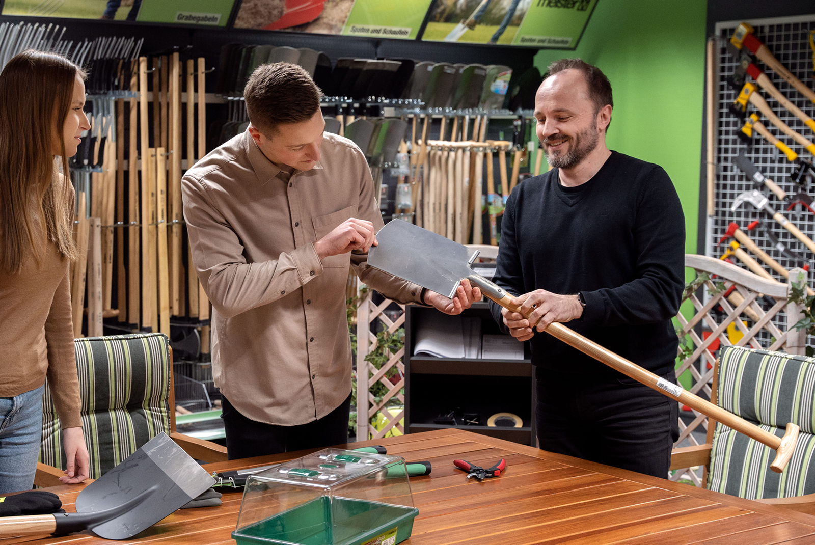 Employees and customers examine a spade with an FSC handle Employees and customers examine a spade with an FSC handle